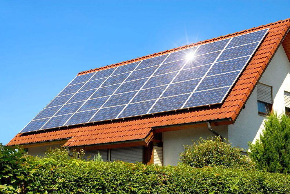Solar Panels On Red Tiled Roof Reflecting The Sun — Stand Fast Electrical Pty Ltd in Warwick, QLD