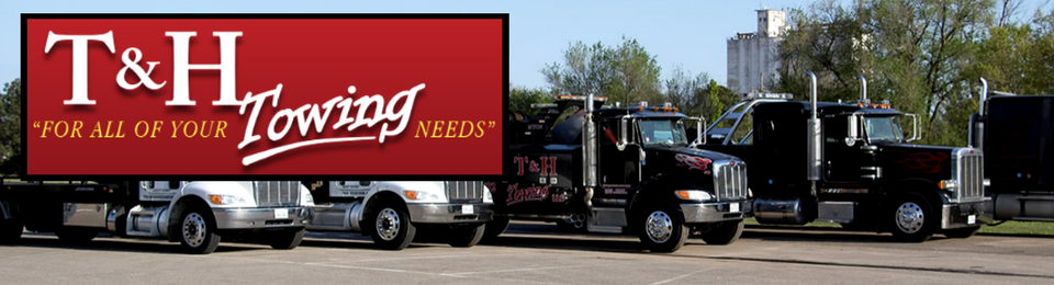 Towing company trucks parked outside. Red sign reads 