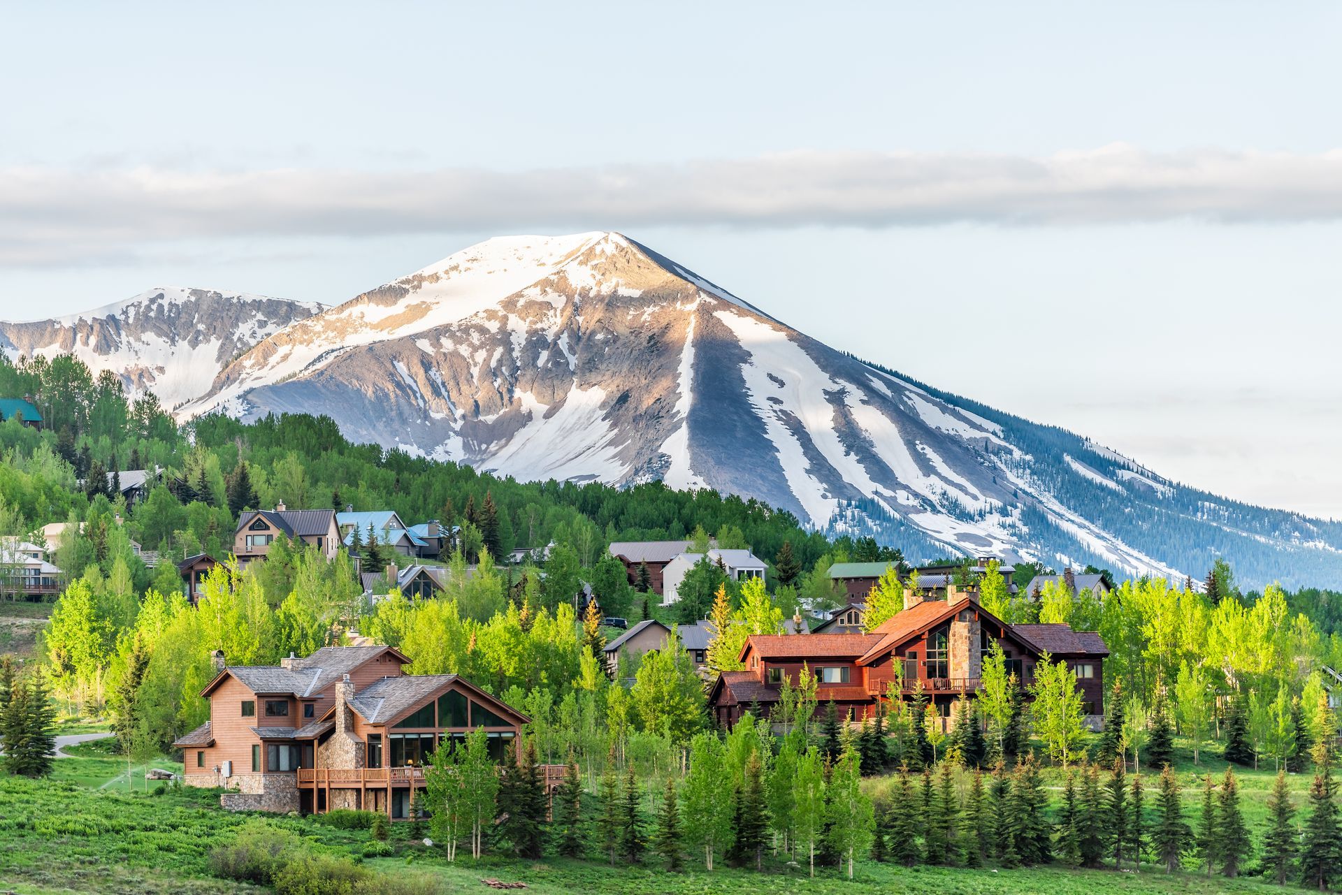 There is a mountain in the background with a lot of houses in the foreground.