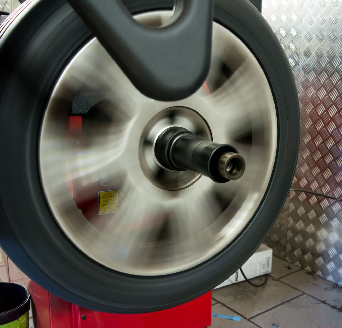 Close-up of a car tire tread with visible wear and road texture