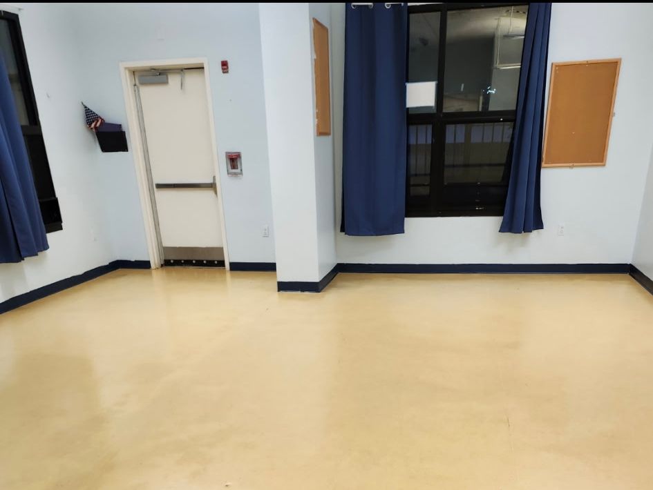 An empty room with a door and a window