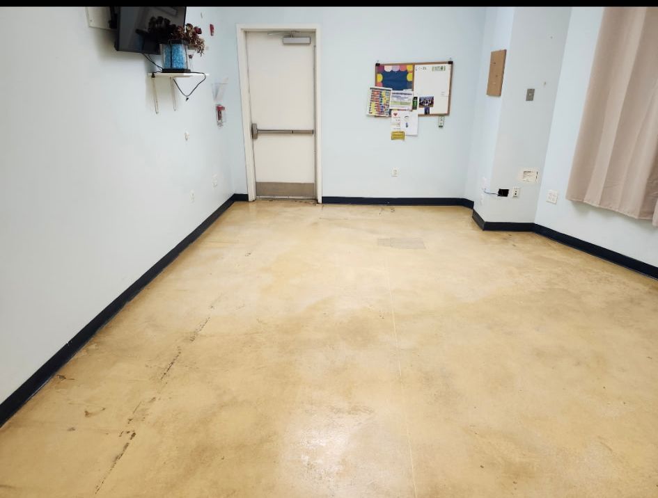 An empty room with a bulletin board on the wall