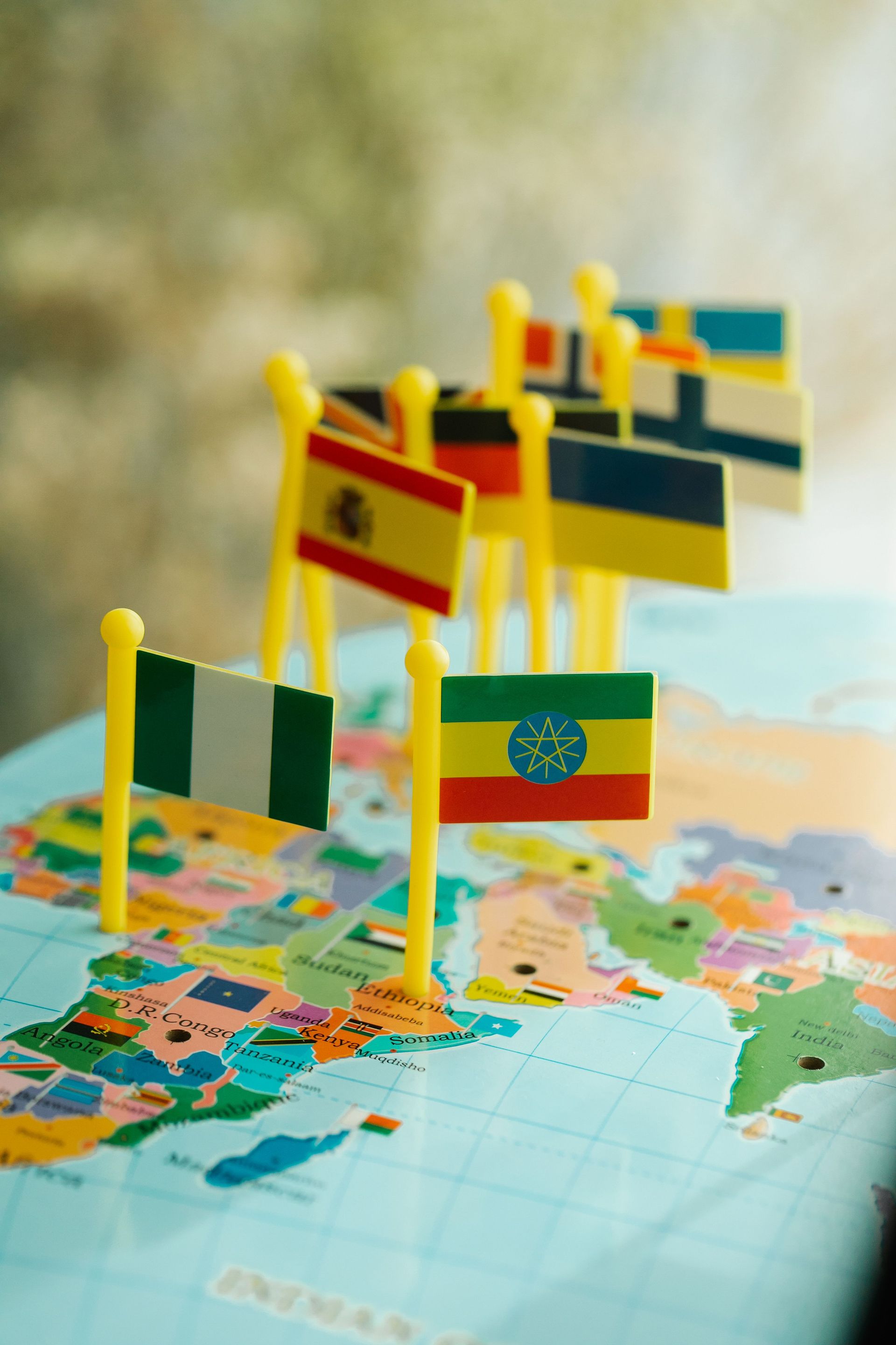 Miniature flags on a world map, including Ethiopia and other countries, marking international locations