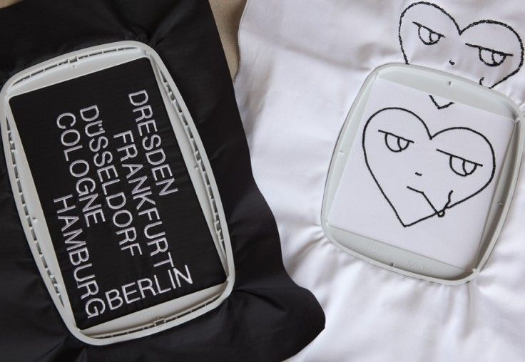 A black and white pillow with the words dresden frankfurt dusseldorf cologne hamburg written on it