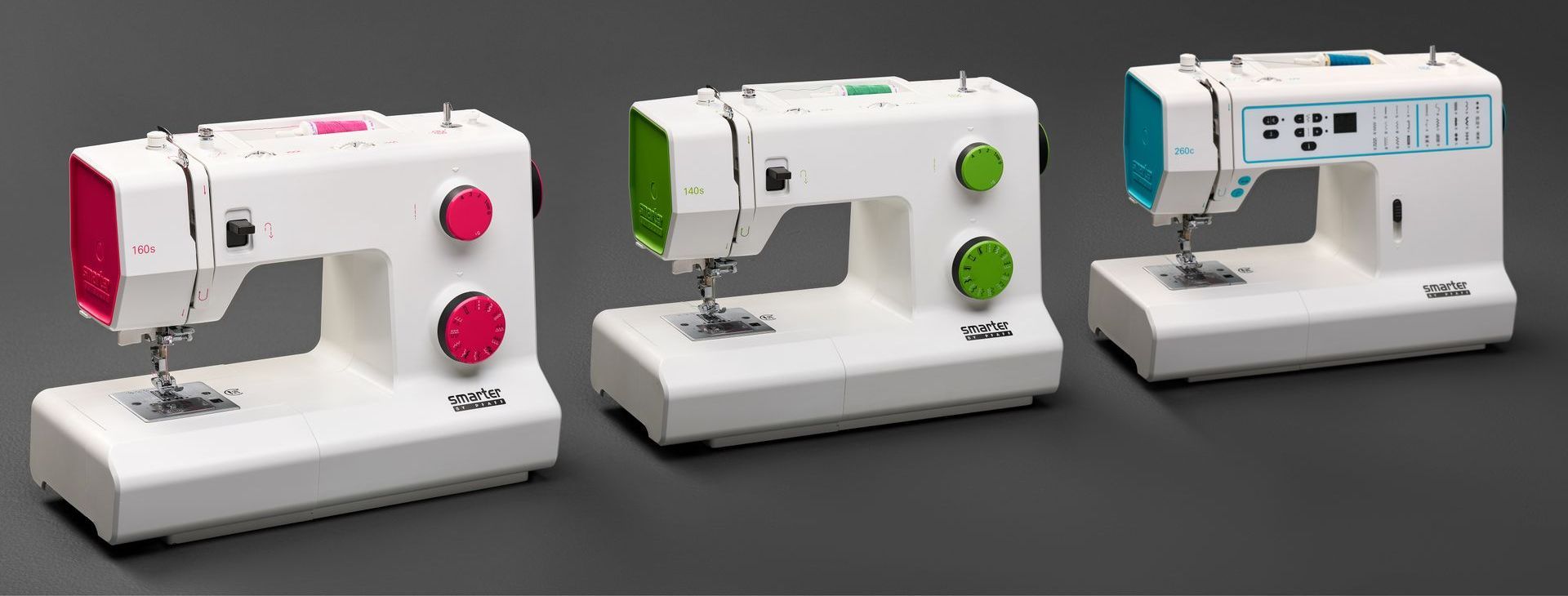 Three sewing machines in white, white with pink accents, and gray with green accents on a gray background
