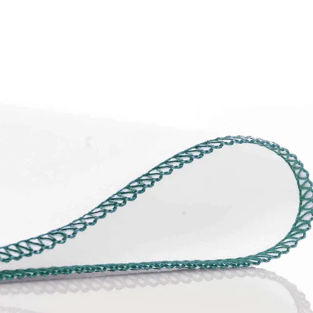 A close up of a white cloth with a green border