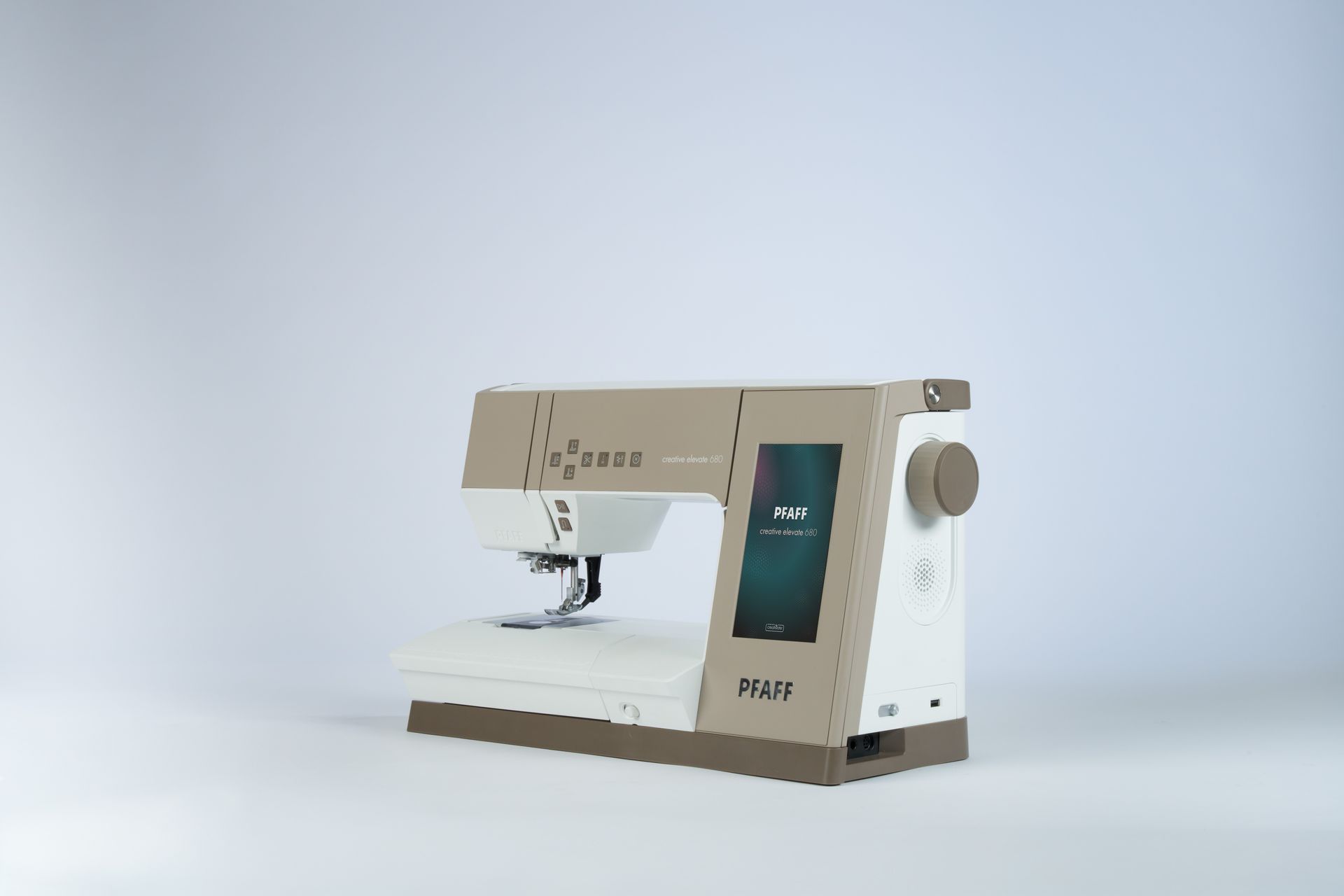 White and blue Pfaff sewing machine on a white surface, shown side view with the needle area visible
