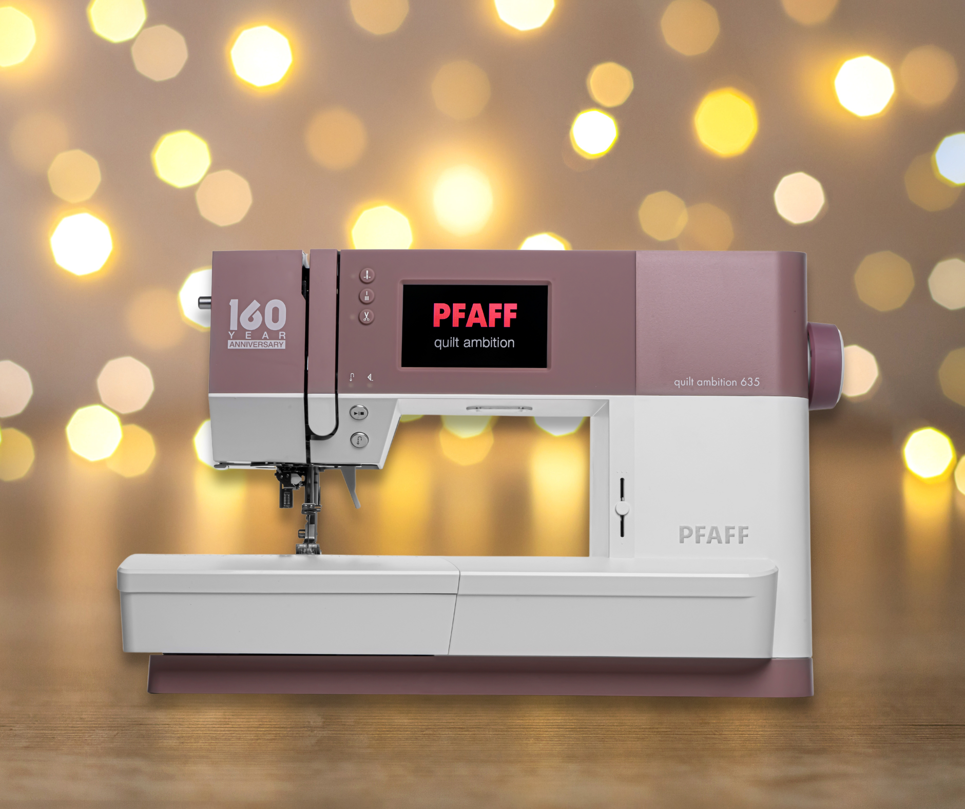 A pink and white pfaff sewing machine is sitting on a wooden table