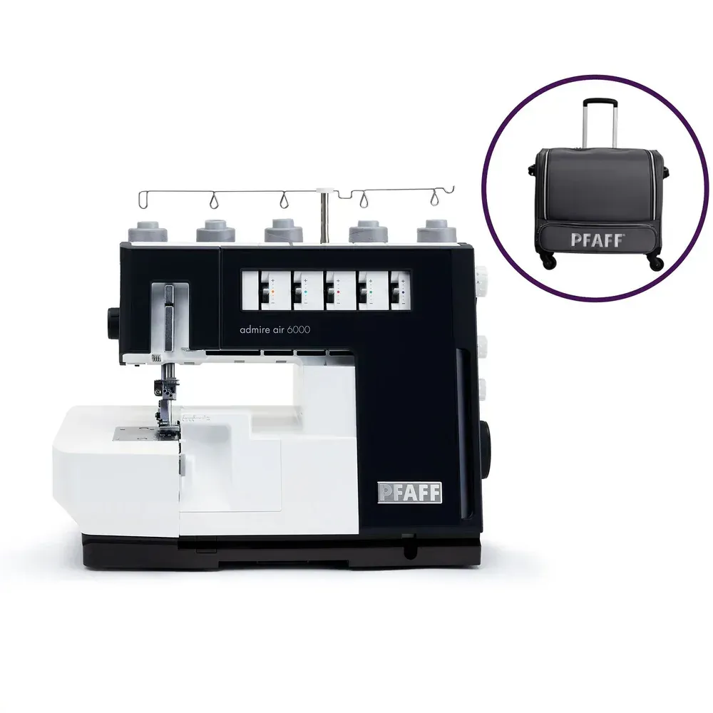 A black and white pfaff sewing machine next to a black suitcase