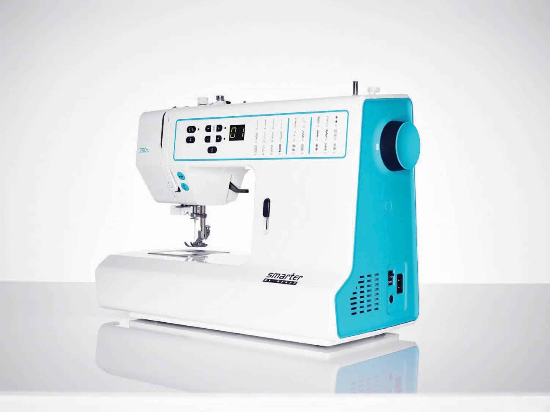 White and turquoise sewing machine on a light background
