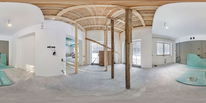 Interior of a room under construction, with drywall on walls and ceiling, window, and unfinished floor.