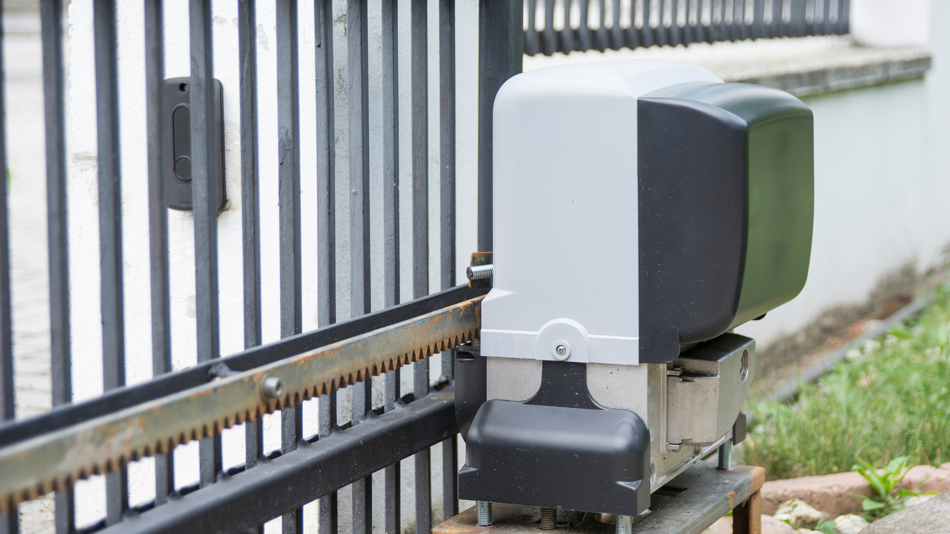 A sliding gate with a motor attached to it.