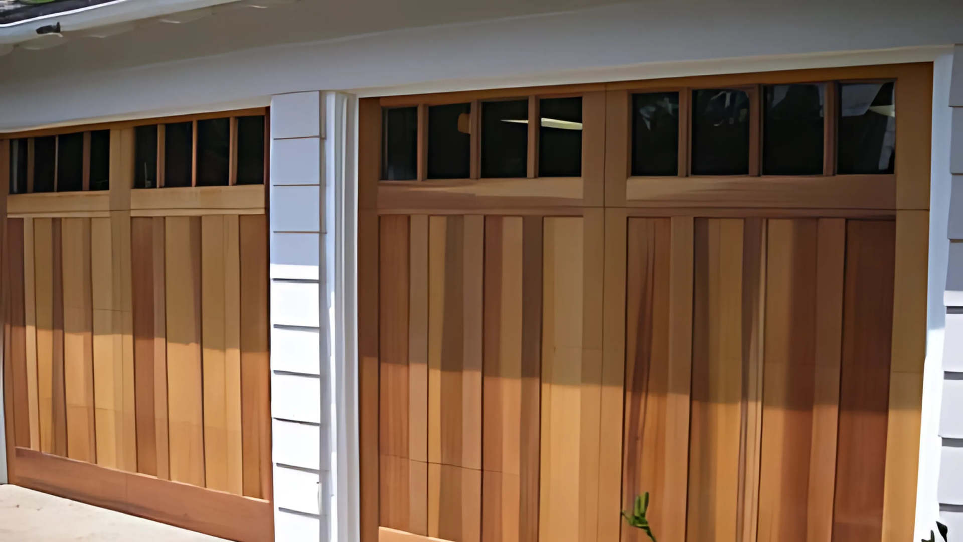 A pair of wooden garage doors on a house