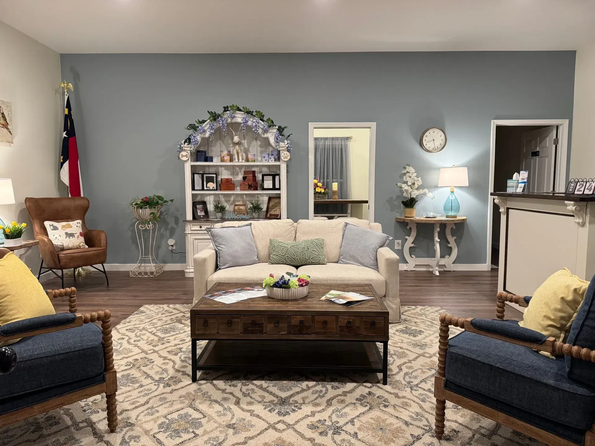 A living room with a couch , chairs , and a coffee table.