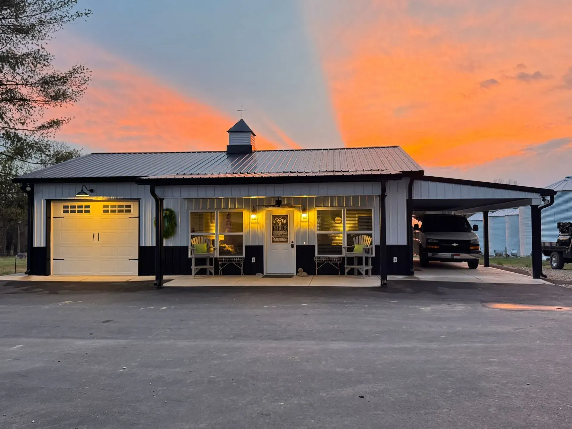A house with a carport and a sunset in the background