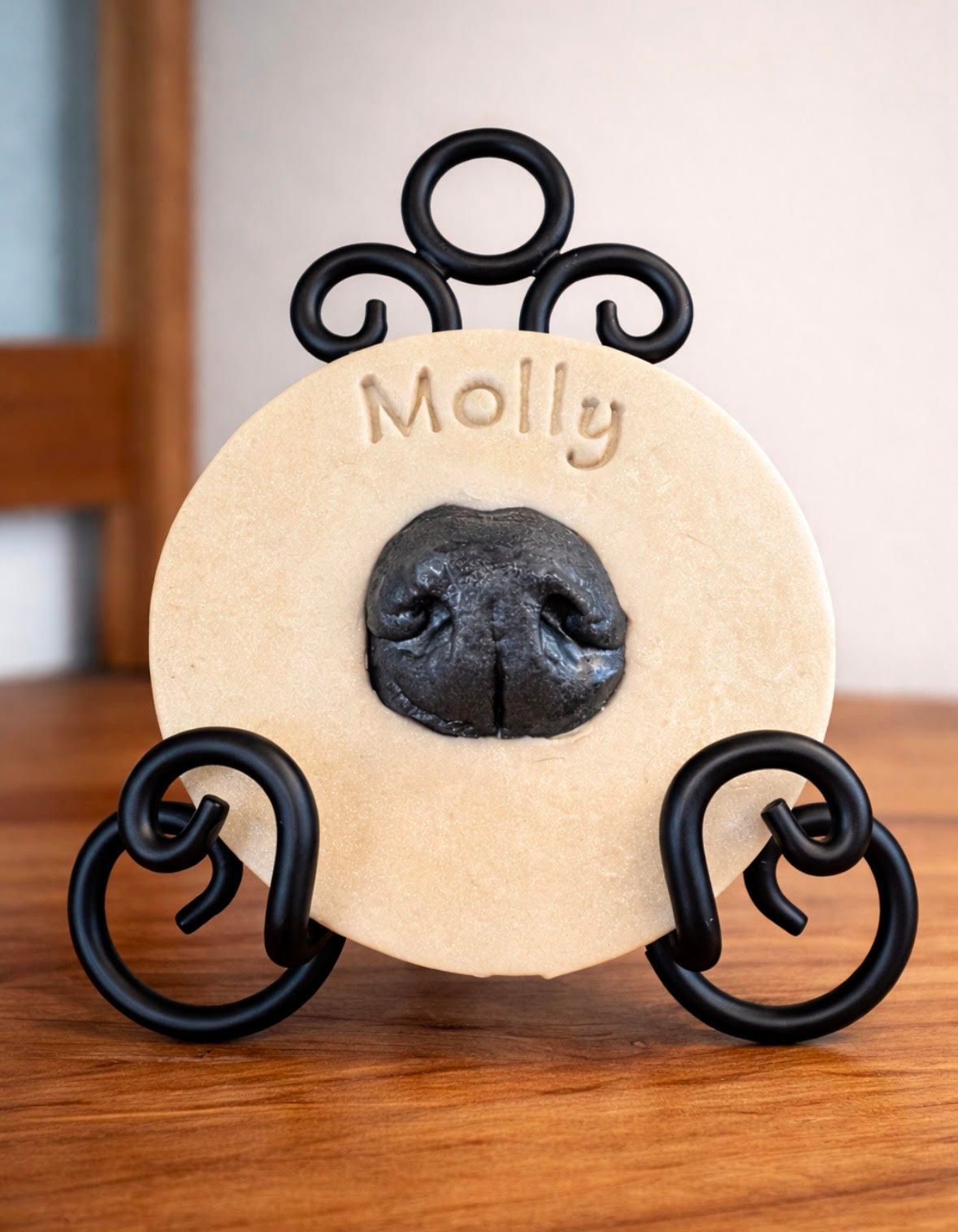 Three wooden circles with paw prints and the words willow forever in our hearts