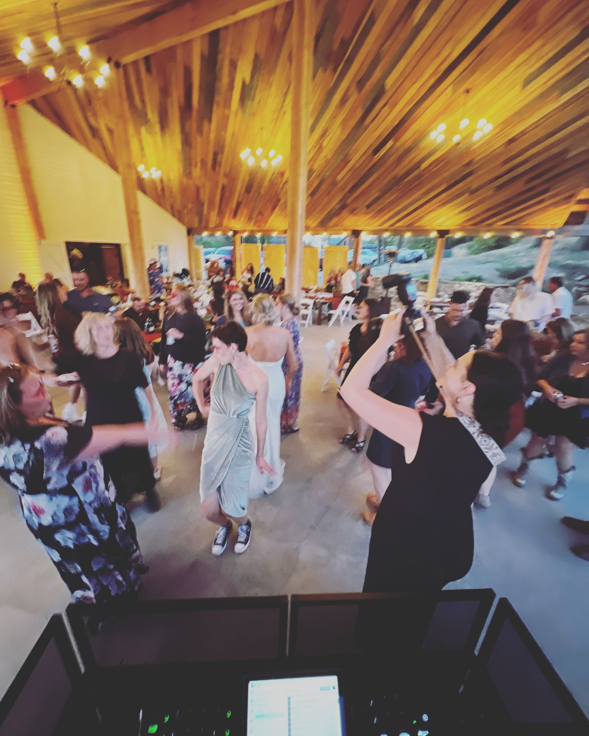 A group of people are dancing in a large room.