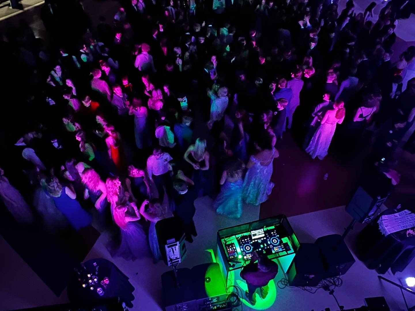 An aerial view of a crowd of people dancing at a party.