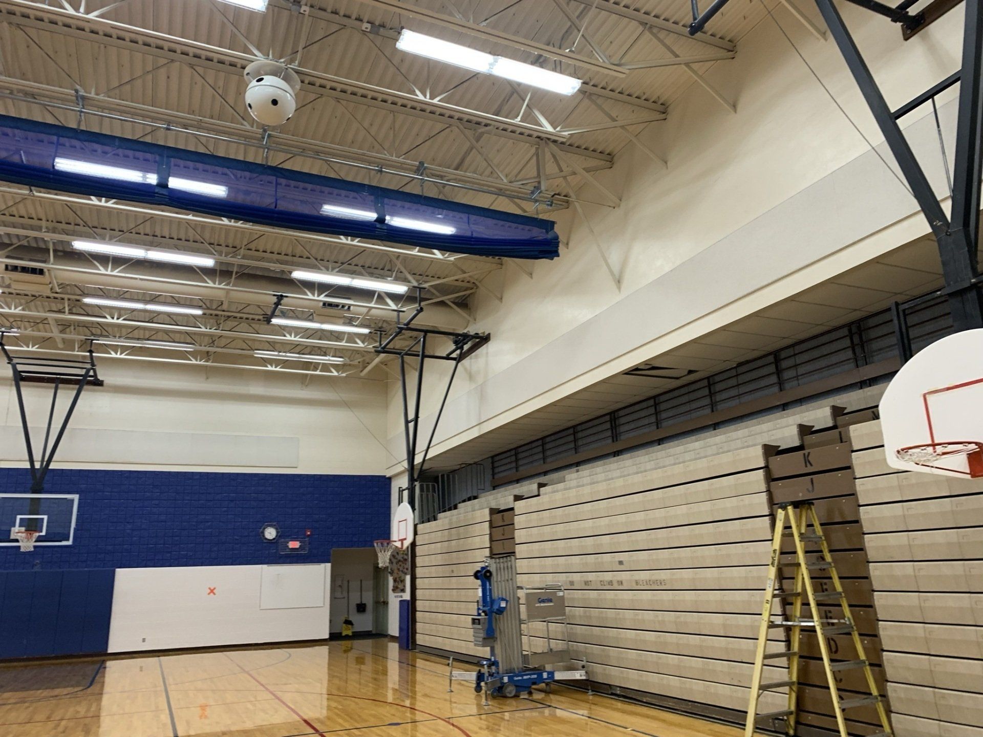 A basketball court with a ladder in the middle of it