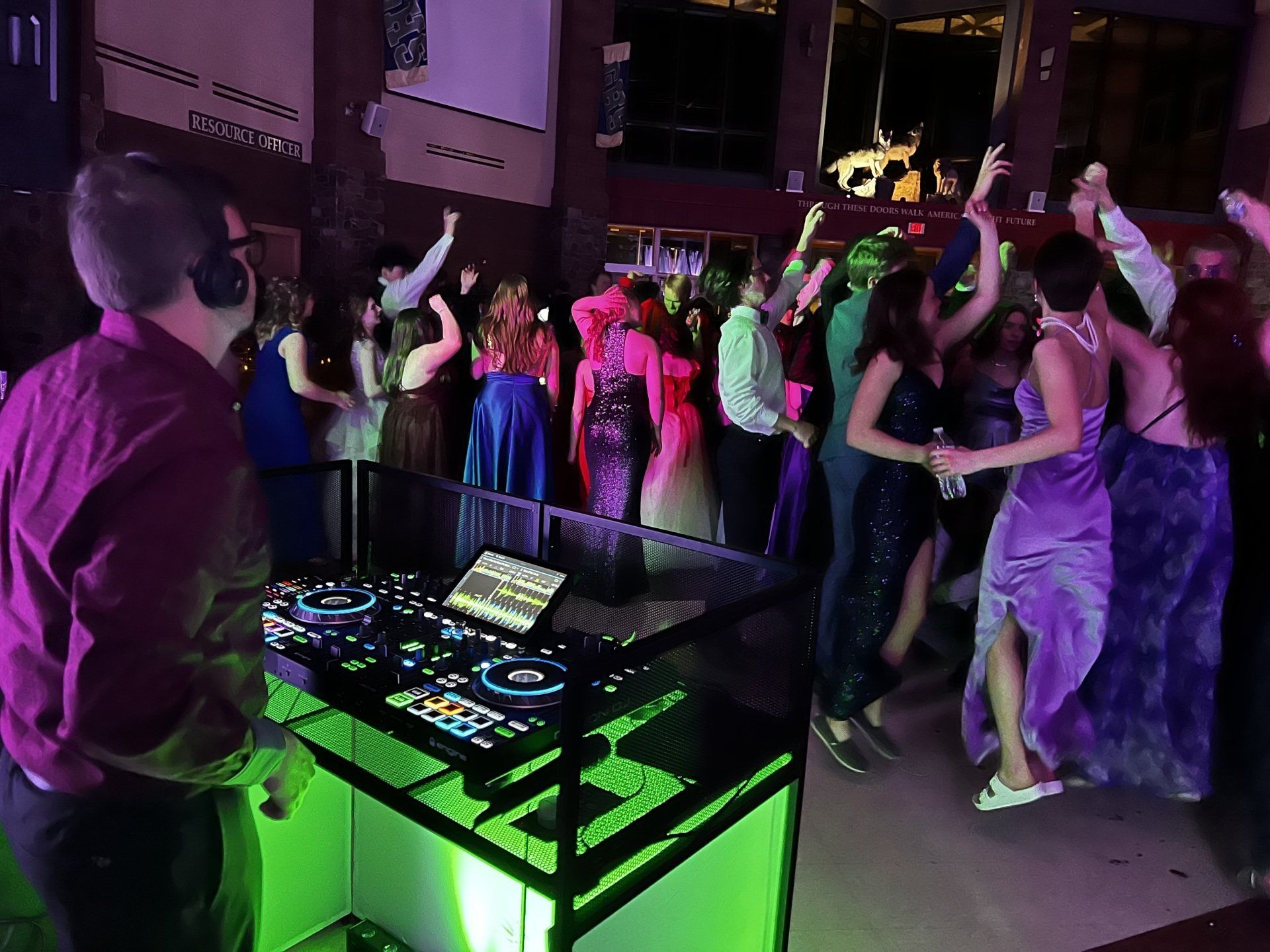 A dj is playing music to a crowd of people at a party.