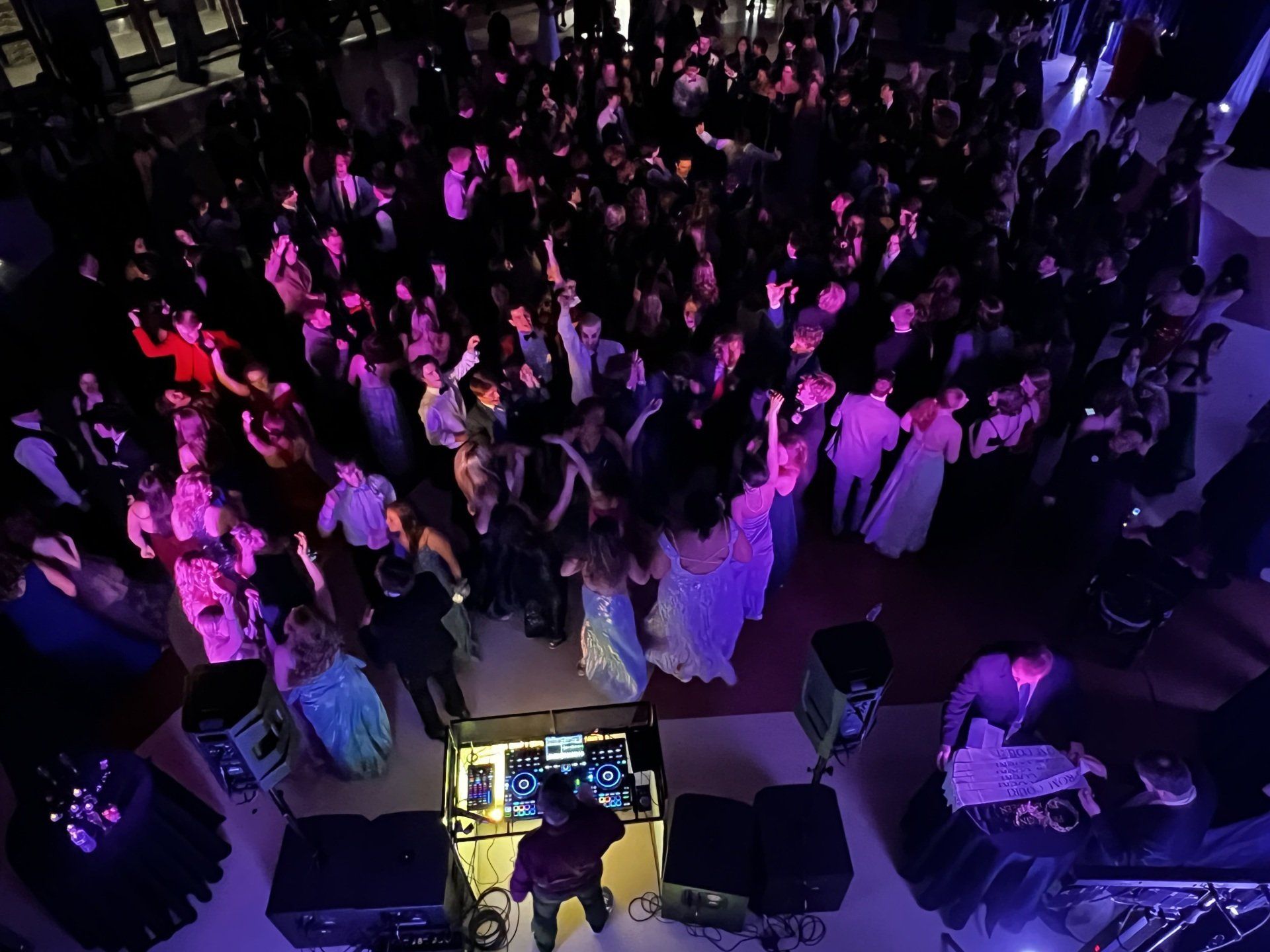 An aerial view of a large crowd of people dancing at a party.