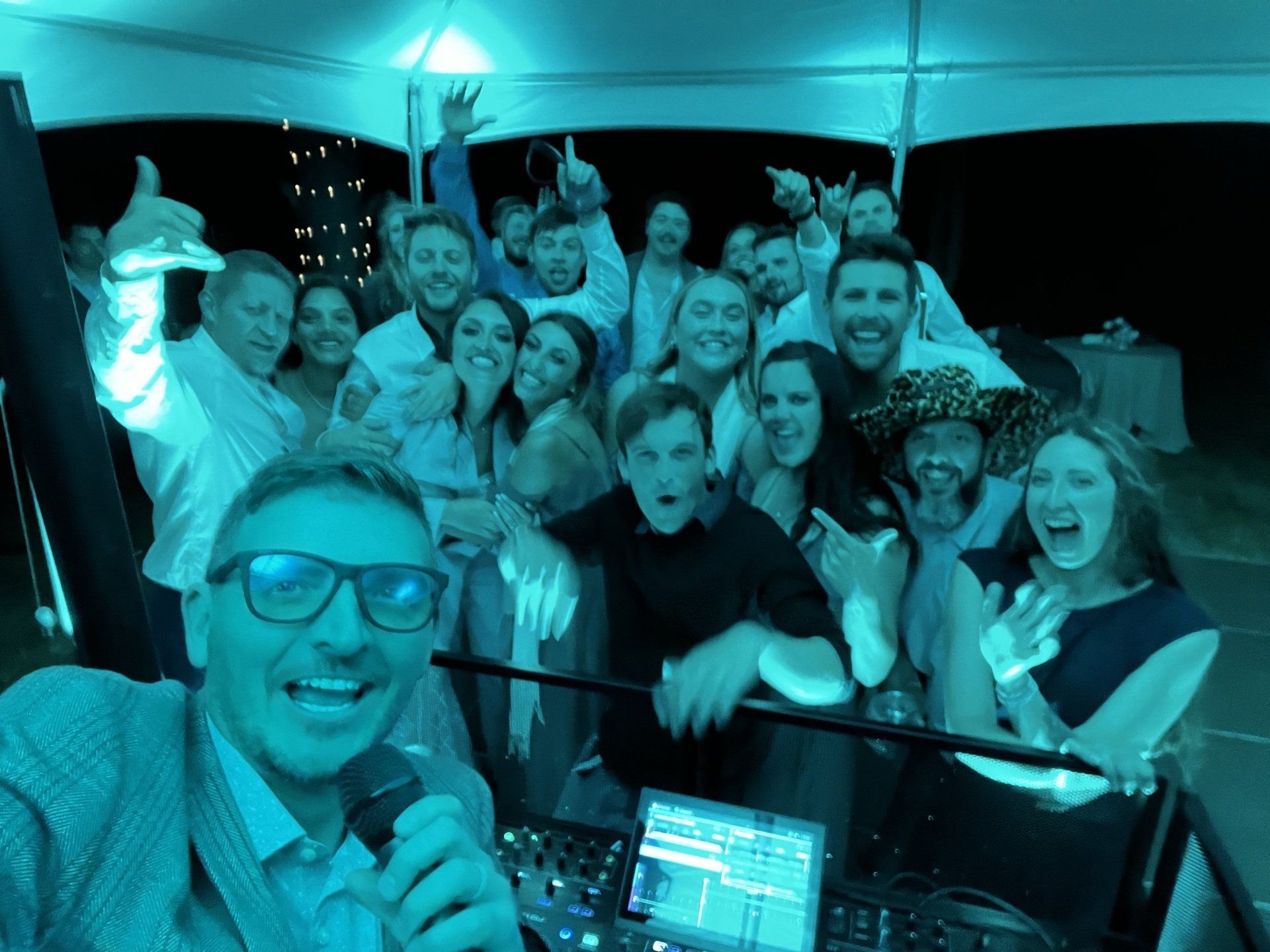 A man is taking a selfie with a group of people at a party.