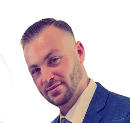 AD Construction NJ (Anthony)- Man in suit, close-up, smiling with a neatly trimmed beard.