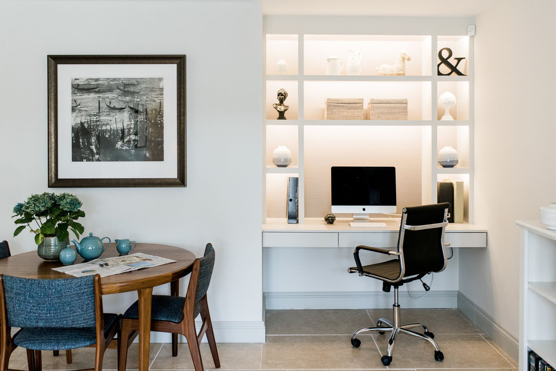 AD Construction NJ - Dining area with a round wooden table, chairs, and artwork, adjacent to a built-in white desk.