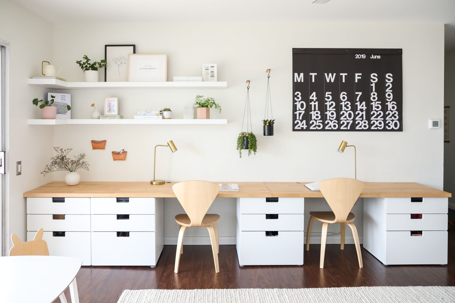 AD Construction NJ - Bright home office with two desks, floating shelves, and a large black calendar on a white wall.