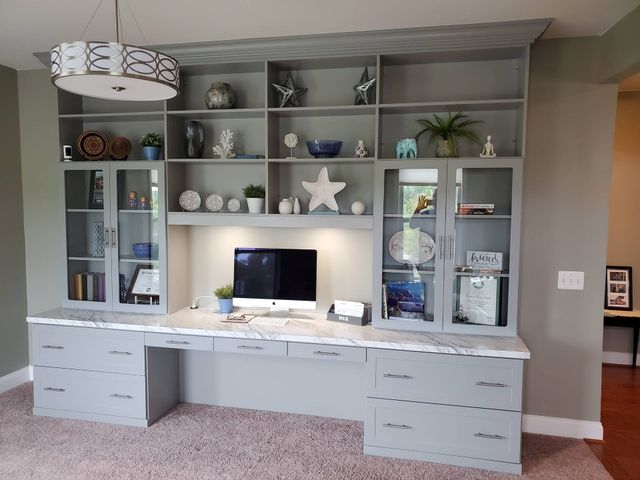 AD Construction NJ - Gray built-in desk with overhead shelves, cabinets, and a desktop computer.