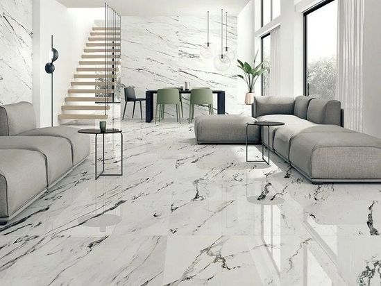AD Construction NJ - Modern living room with marble flooring and wall, gray sofas, and dining table.