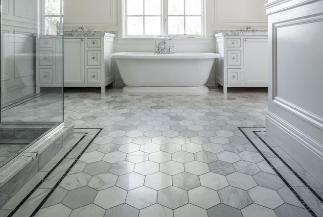 AD Construction NJ - Elegant white bathroom with marble hexagon floor, freestanding tub, and two vanities.