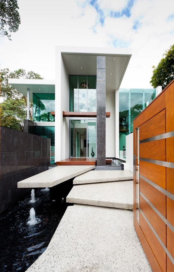 A Modern House With A Fountain In Front Of It — Datco Aluminium Pty Ltd In Murwillumbah, NSW 