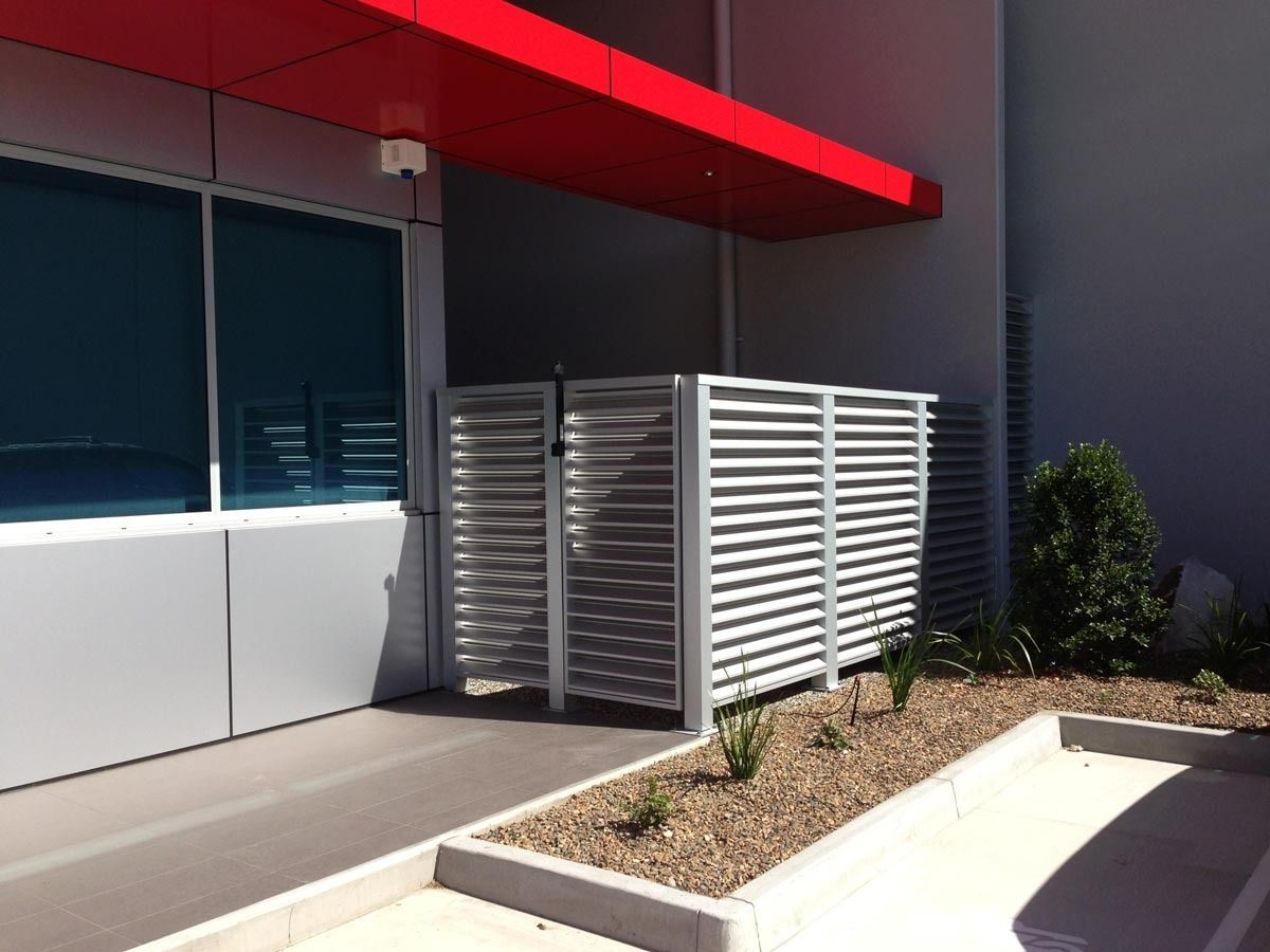 A Building With A Red Awning And A White Fence — Datco Aluminium Pty Ltd In Murwillumbah, NSW