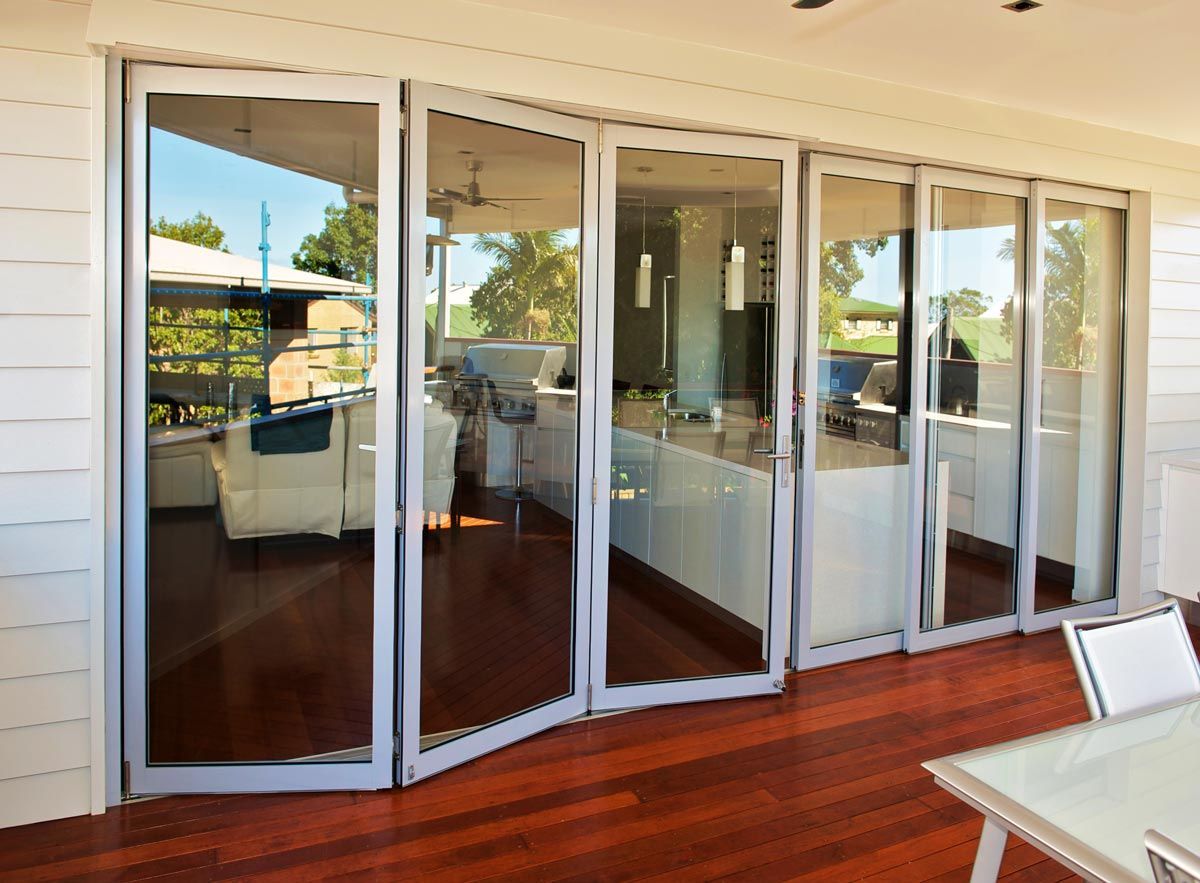 A Room With A Lot Of Glass Doors And A Table — Datco Aluminium Pty Ltd In Murwillumbah, NSW 