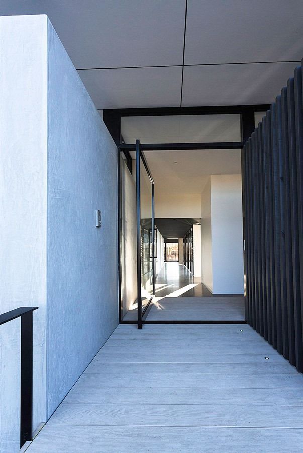 A Long Hallway With A Glass Door Leading To A Building — Datco Aluminium Pty Ltd In Murwillumbah, NSW 