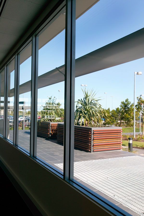 A Building With a Lot of Windows Looking Out to a Parking Lot — Datco Aluminium Pty Ltd In Murwillumbah, NSW