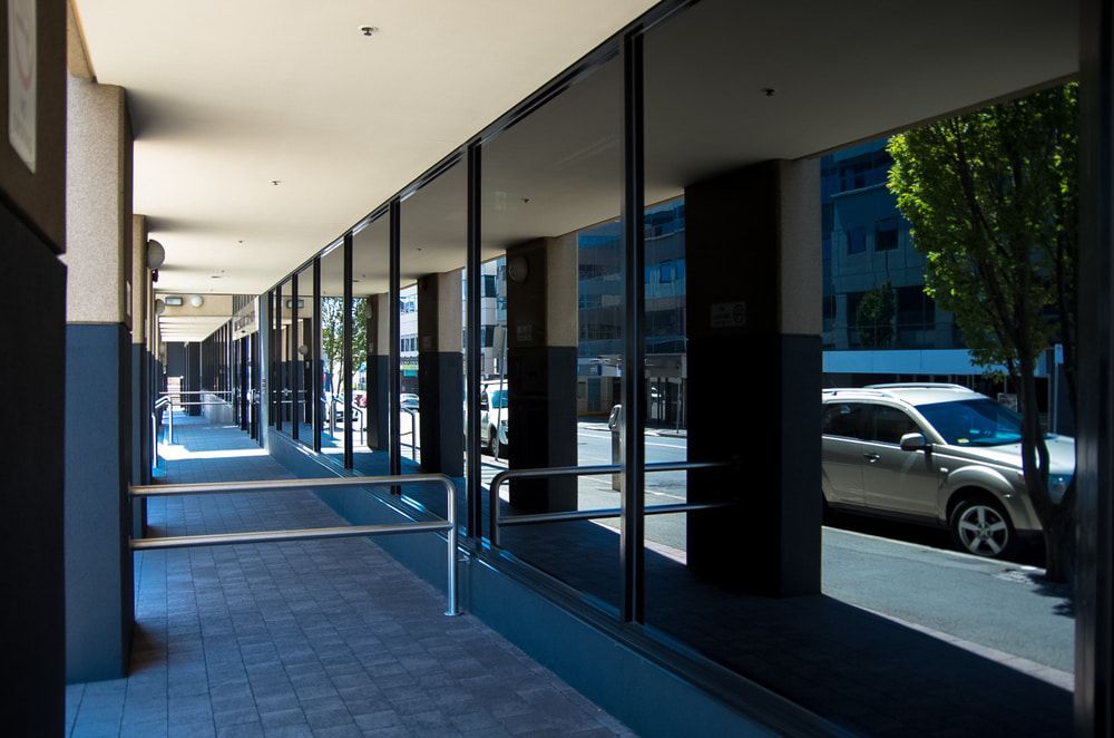 A Car Is Parked On The Side Of The Road In Front Of A Building — Datco Aluminium Pty Ltd In Yamba, NSW