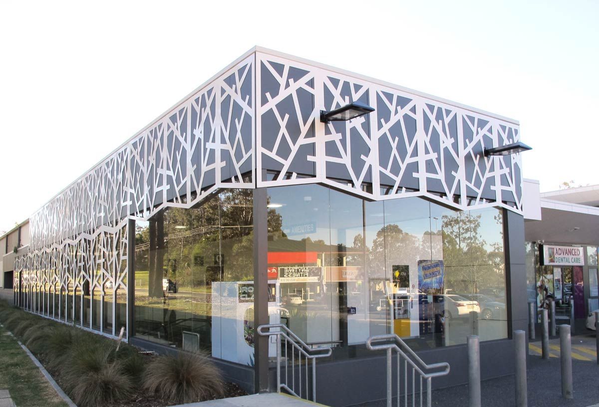 A Large Building With a Geometric Design on the Side of It — Datco Aluminium Pty Ltd In Murwillumbah, NSW