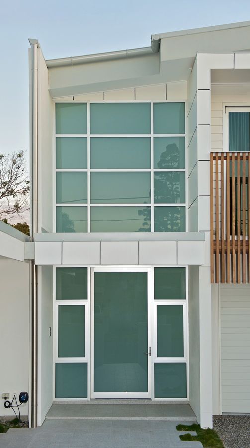 A White House With a Large Door and Windows — Datco Aluminium Pty Ltd In Murwillumbah, NSW