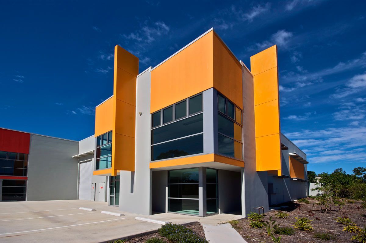 A large yellow and white building with a lot of windows