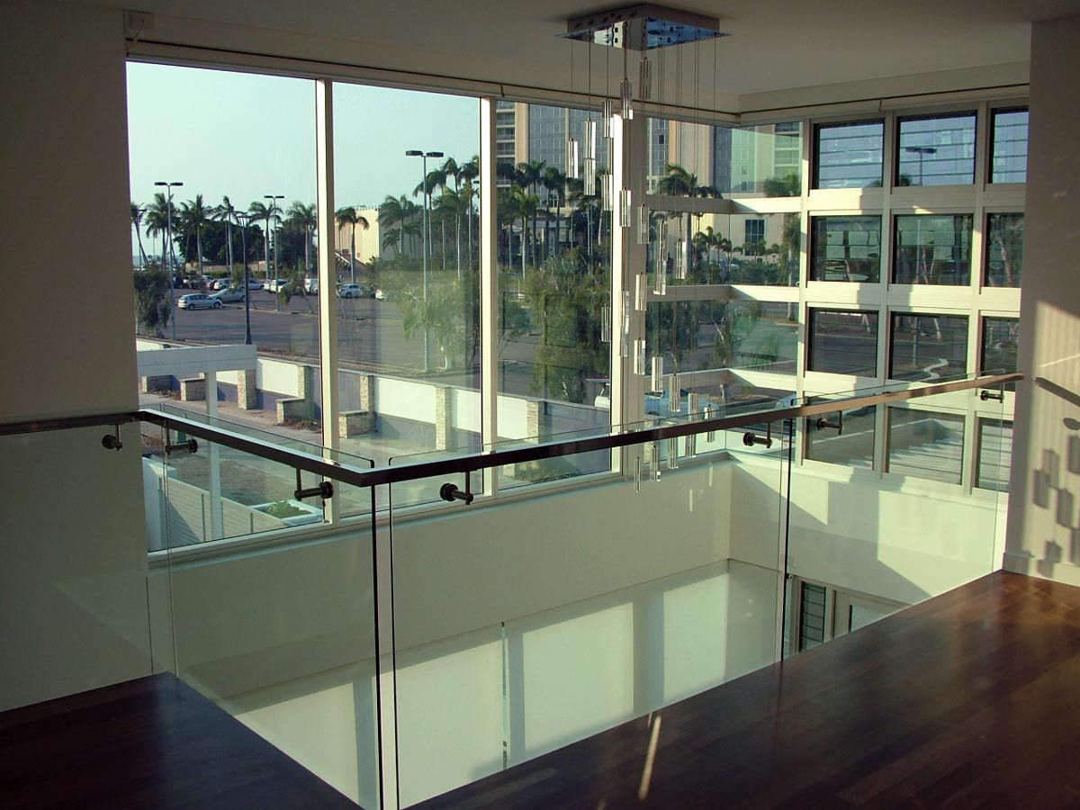 A Staircase With a Glass Railing and Lots of Windows — Datco Aluminium Pty Ltd In Murwillumbah, NSW