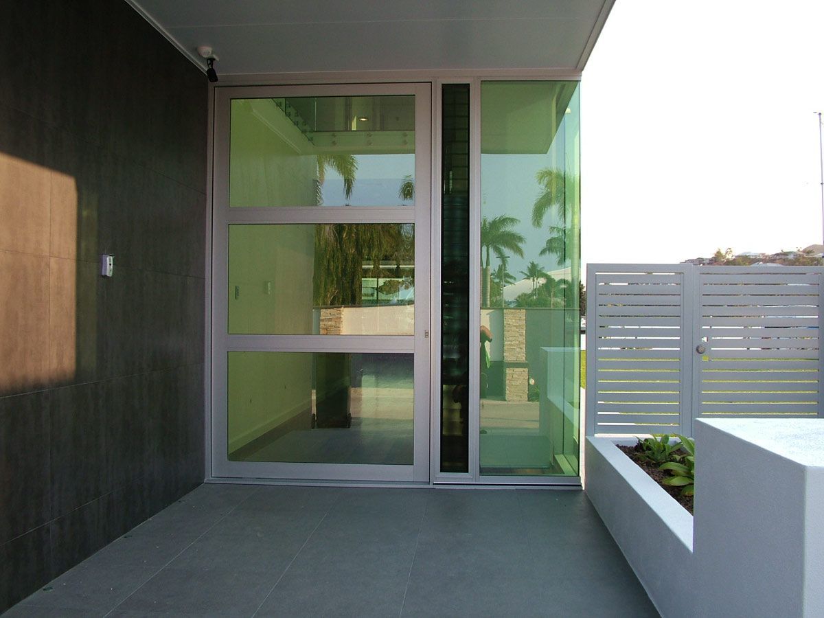 A Modern House With A Large Glass Door — Datco Aluminium Pty Ltd In Kingscliff, NSW