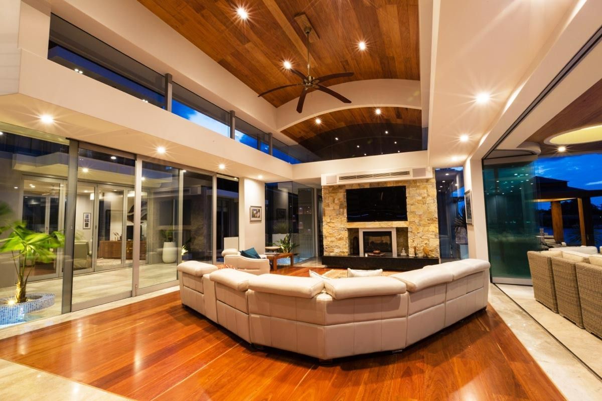 A Living Room With A Large Couch And A Fireplace — Datco Aluminium Pty Ltd In Kyogle, NSW