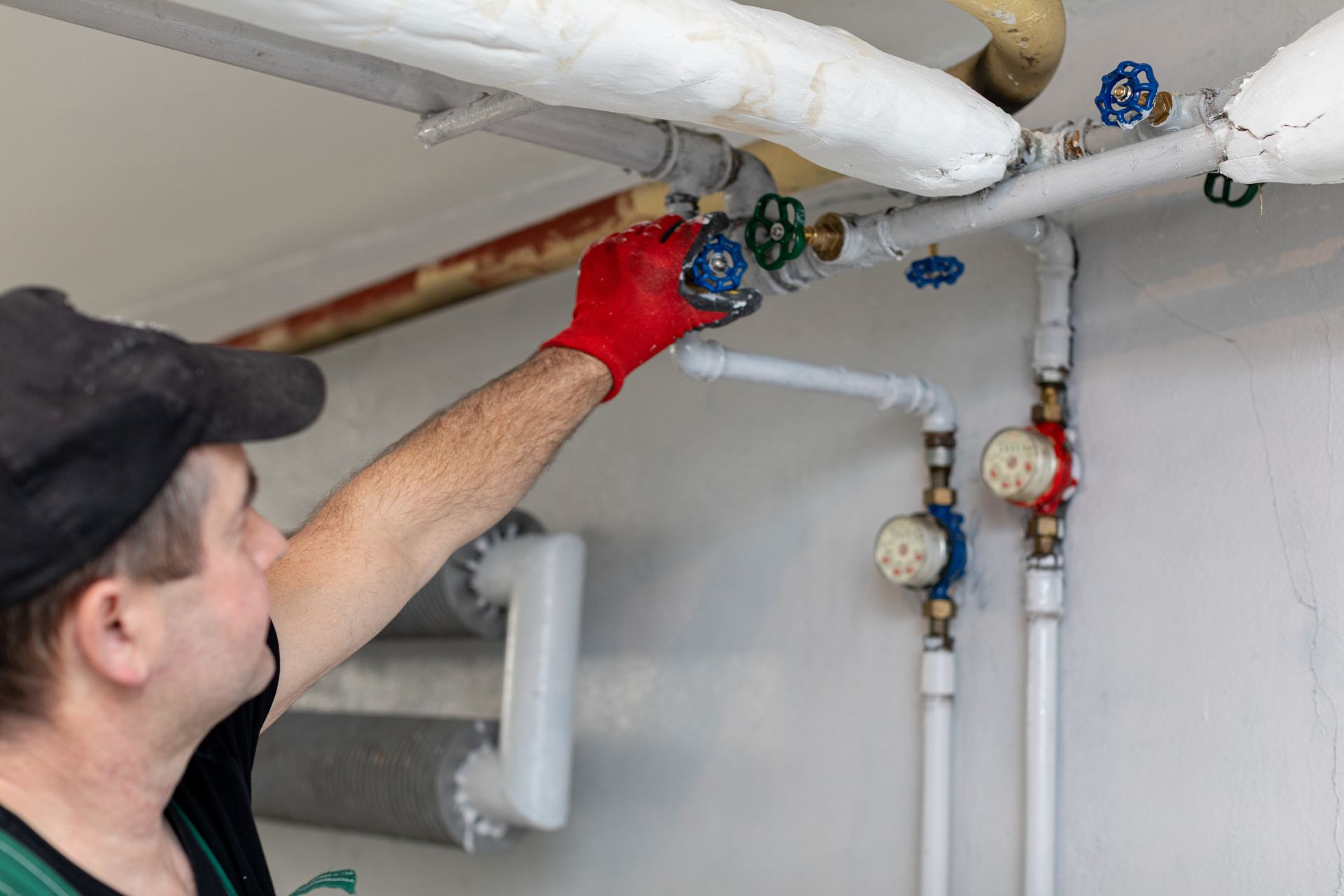 Plumber working on an industrial piping system.