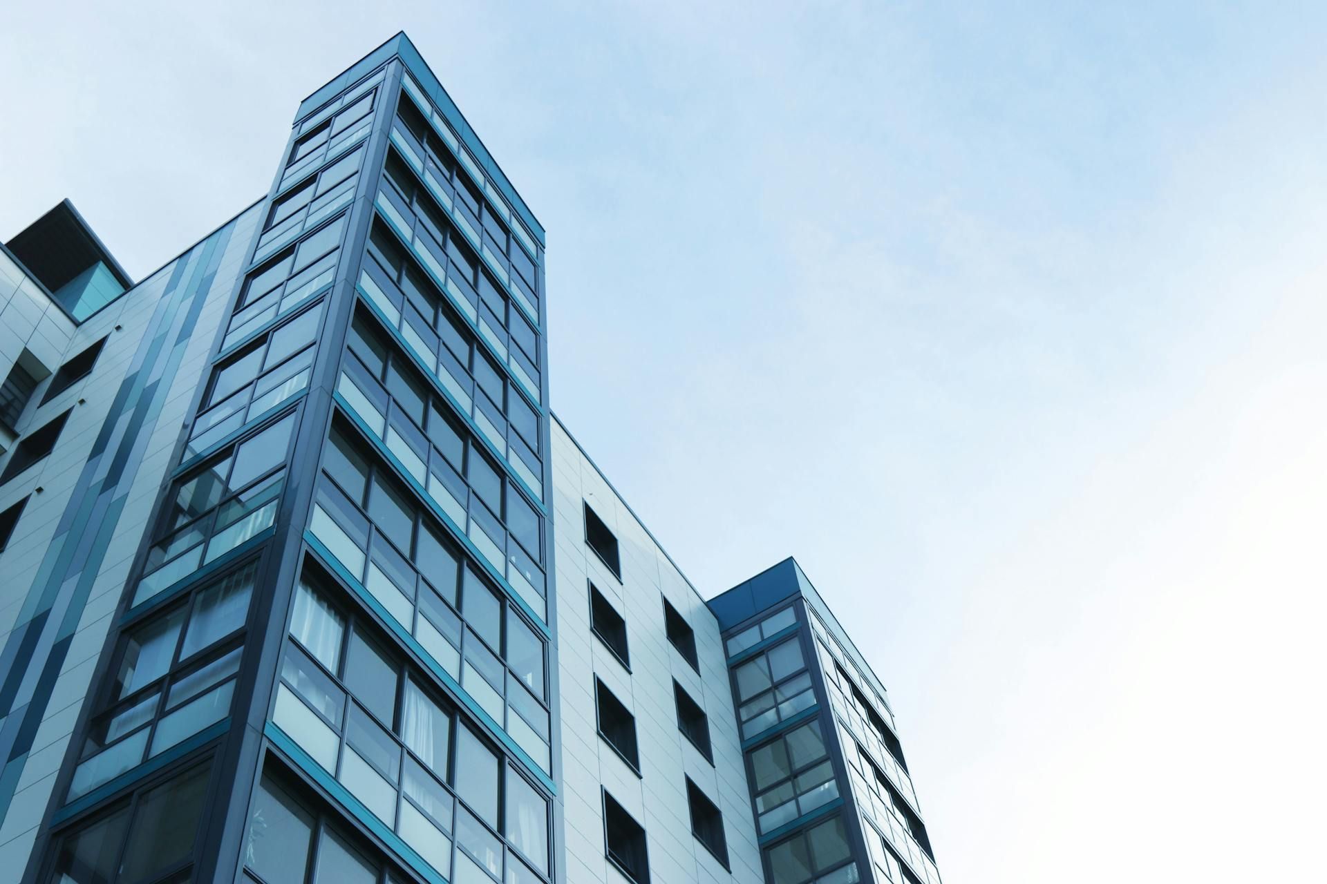 Looking up at a tall building with a blue sky in the background.