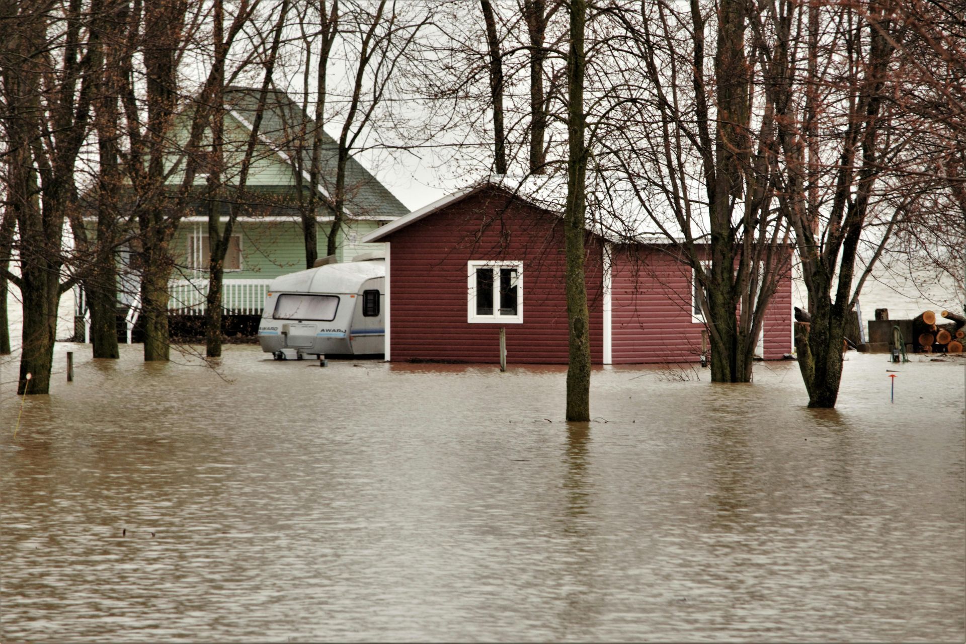 A family is walking towards a car in front of a house. 