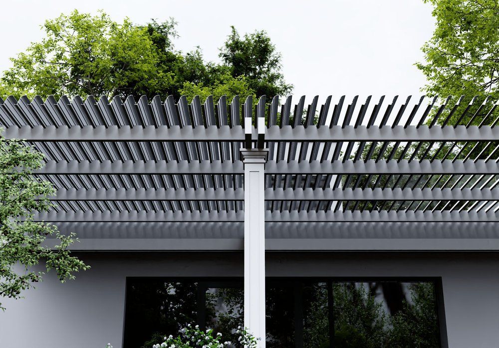 A pergola with trees on top of it is on the side of a house.