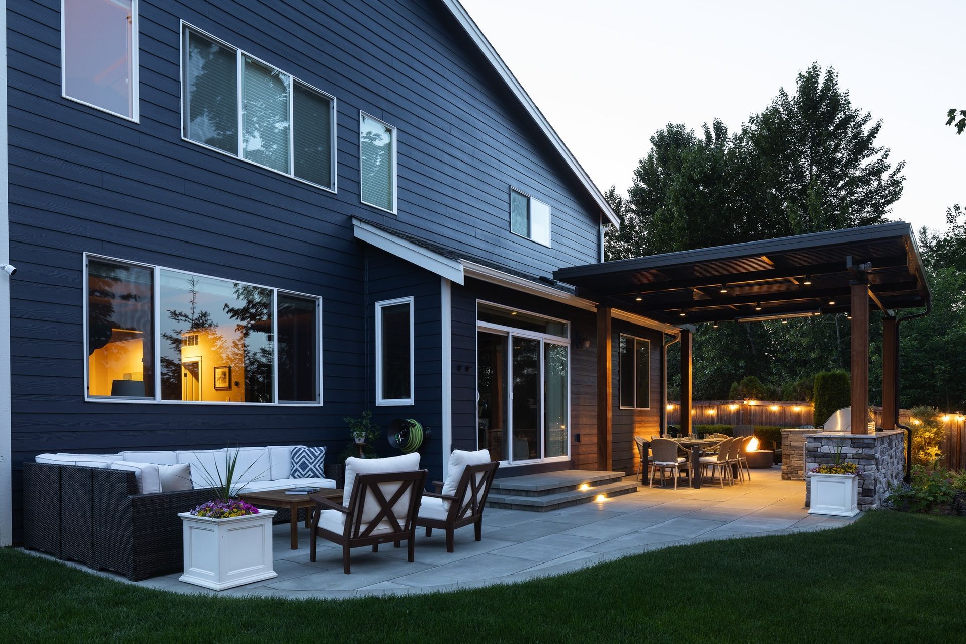 A large house with a patio area in front of it