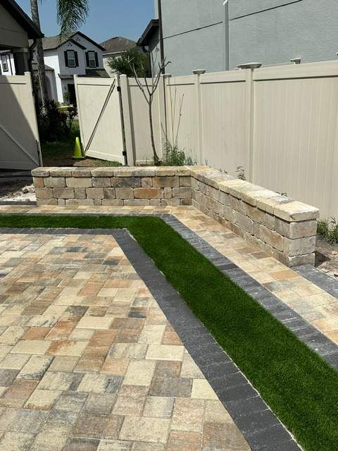 Flagstone's Union Cream/Beige/Charcoal pavers with Coordinating Cream/Beige/Charcoal Fire Pit and Sitting Wall and Turf Inlays with Charcoal Border